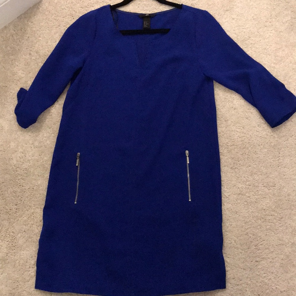Royal blue dress with silver zipper pockets.